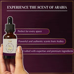 Bottle of scented oil held by a hand with text about the scent of Arabia on a dark background